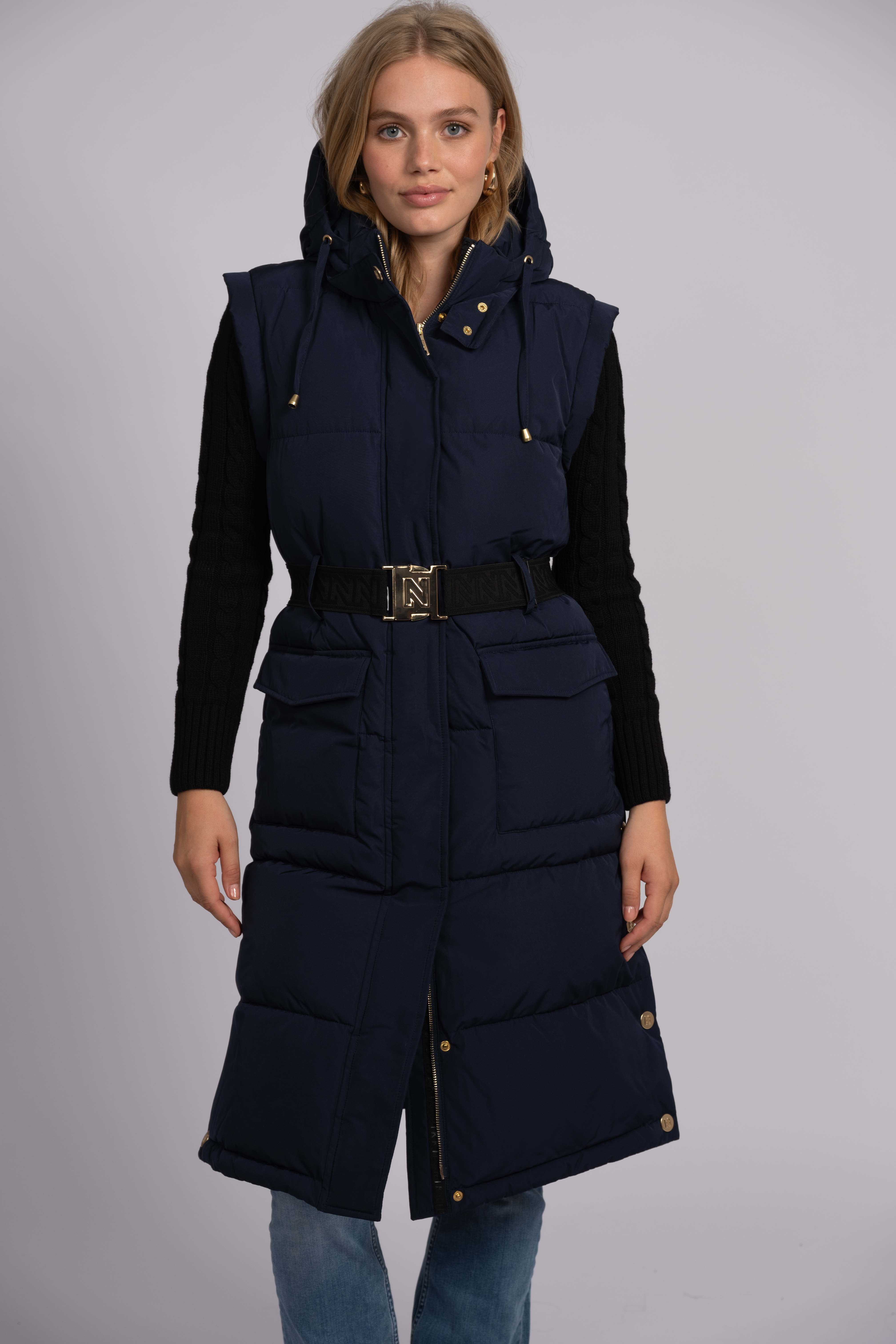 Long puffer jacket with belt and detachable sleeves